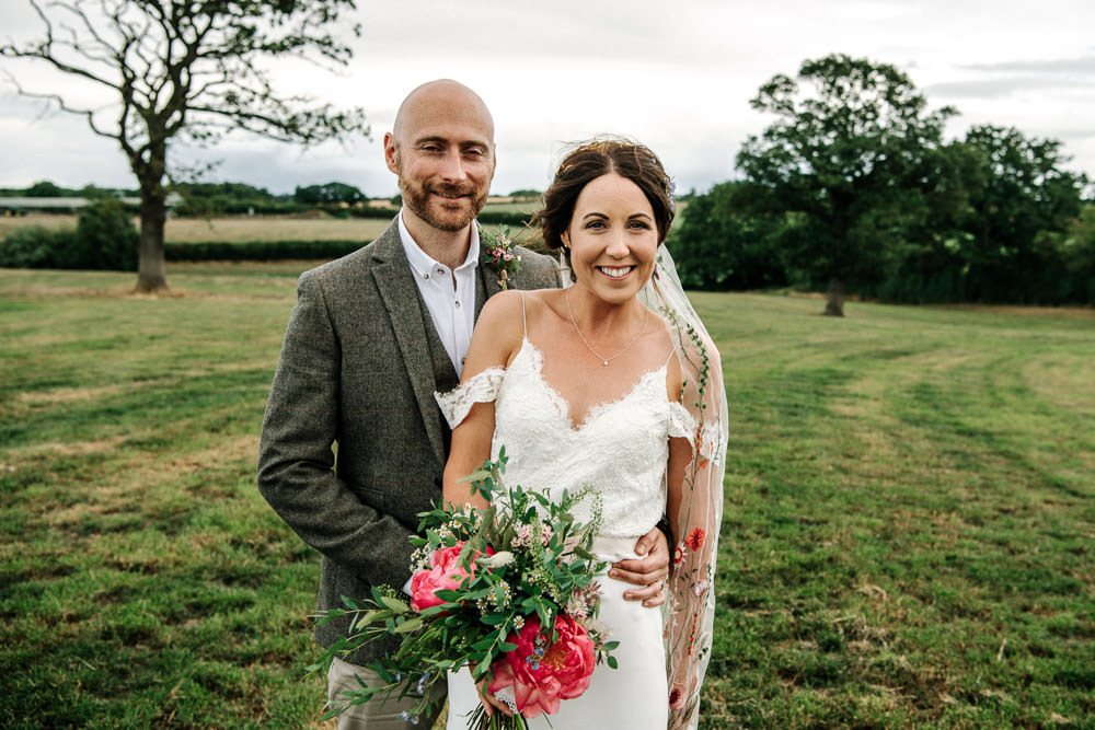 Bride Bridal Dress Gown Lace Detail Drop Cold Shoulder Ribbon Bow Sleeveless Tweed Suit Waistcoat Groom Floral Veil Bouquet Stanford Farm Wedding Andy Griffiths Photography
