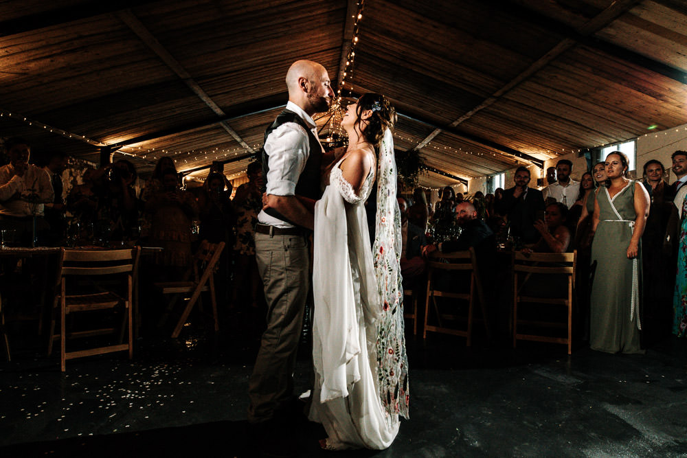 Bride Bridal Dress Gown Lace Detail Drop Cold Shoulder Ribbon Bow Sleeveless Tweed Suit Waistcoat Groom Floral Veil Stanford Farm Wedding Andy Griffiths Photography