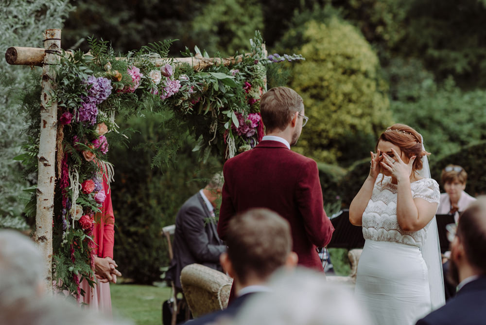 Bride Bridal Short Cap Sleeve Slip Dress Laure de Sagazan Dress Gown V Back Veil Red Wine Burgundy Suit Ceremony Arch Floral Foliage Felin Newydd House Wedding Christopherian.co.uk