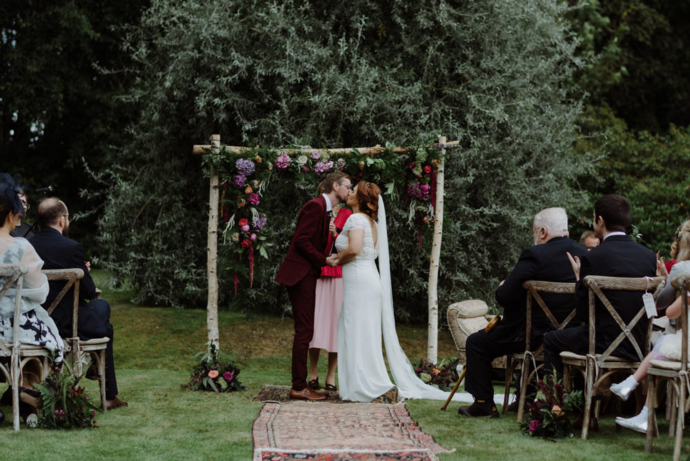 Bride Bridal Short Cap Sleeve Slip Dress Laure de Sagazan Dress Gown V Back Veil Red Wine Burgundy Suit Ceremony Arch Veil Flowers Floral Persian Rug Felin Newydd House Wedding Christopherian.co.uk