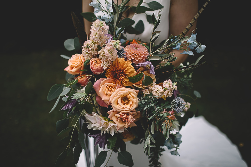 Bouquet Flowers Bride Bridal Coral Peach Rose Dahlia Thistle Greenery Feather Gilbert Whites House Barn Wedding Carrie Lavers Photography