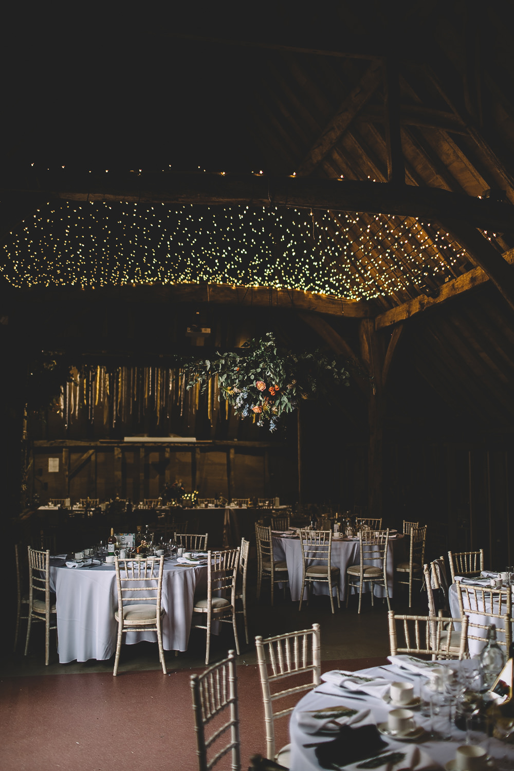 Hanging Suspended Flowers Greenery Rose Orange Coral Decor Fairy Light Canopy Gilbert Whites House Barn Wedding Carrie Lavers Photography