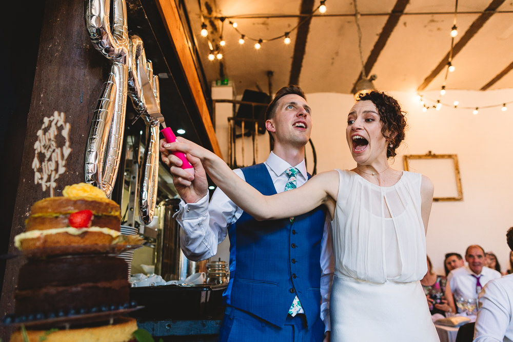 Bride Bridal Dress Gown Bias Cut Art Deco Three Piece Blue Waistcoat Suit Groom Cake Cutting Clapton Country Club Wedding Kate Jackson Photography