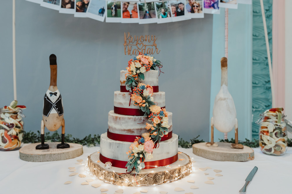 Semi Naked Cake Ribbon Wood Slice Sugar Flowers Wooden Duck Sun Pavilion Wedding Stevie Jay Photography
