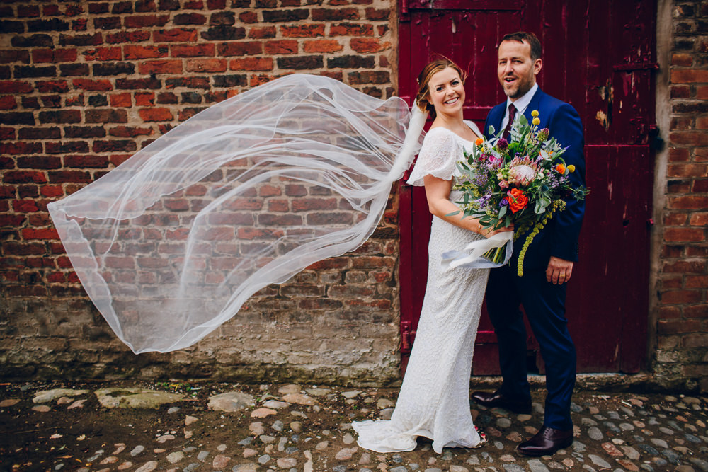 Bride Bridal V Neck Sleeves Beaded Detail Dress Gown Blue Suit Groom Veil Tropical Bouquet Tatton Wedding Stock Farm Barn Amy B Photography