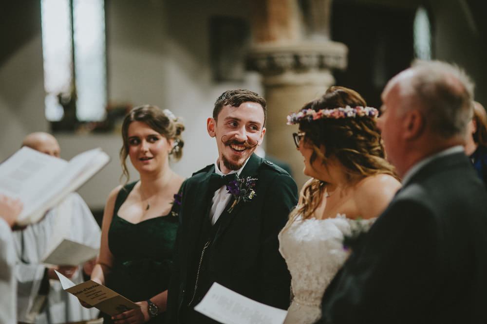 Bride Bridal Lace Sleeves Overlay A Line Dress Gown Flower Crown Kilt Green Jacket Groom Bow Tie Ash Farm Barns Wedding Flawless Photography