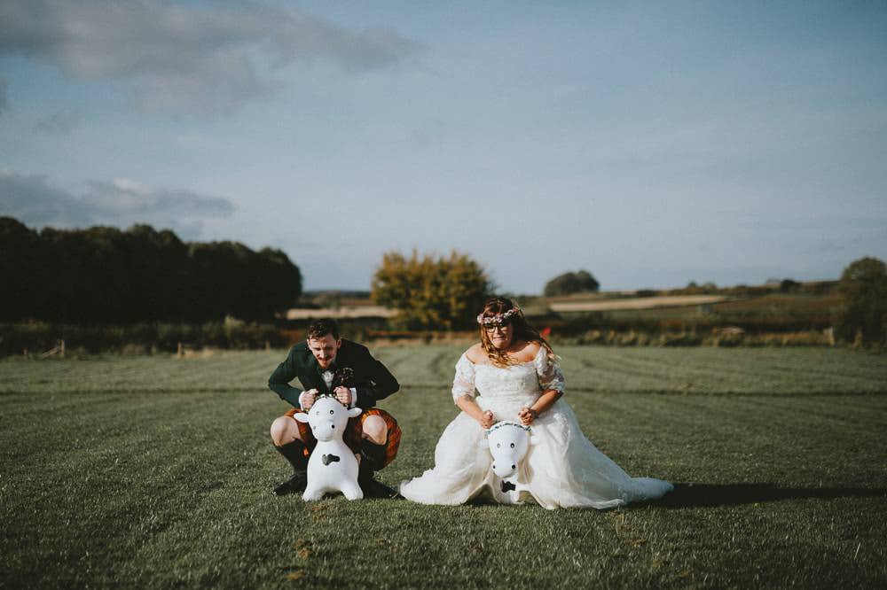Bride Bridal Lace Sleeves Overlay A Line Dress Gown Flower Crown Kilt Green Jacket Groom Bow Tie Space Hoppers Ash Farm Barns Wedding Flawless Photography