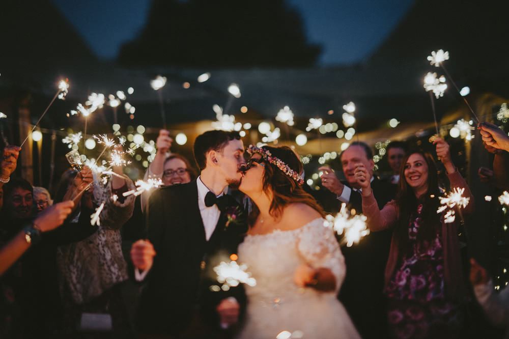 Bride Bridal Lace Sleeves Overlay A Line Dress Gown Flower Crown Kilt Green Jacket Groom Bow Tie Sparkler Send Off Farewell Ash Farm Barns Wedding Flawless Photography