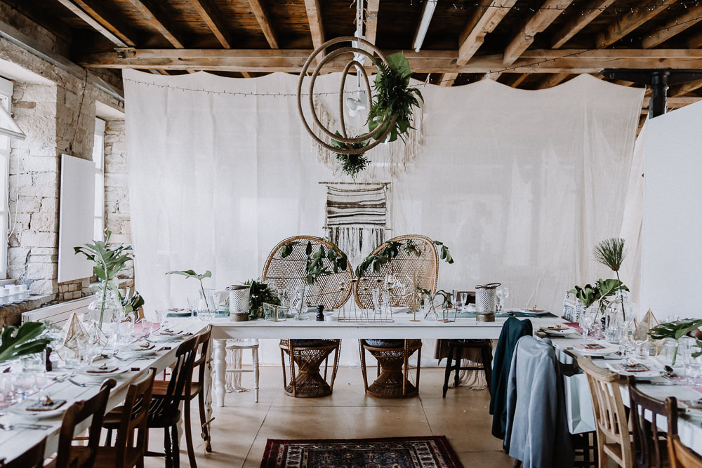 Bohemian Reception Room Decor Macramé Persian Rugs Hanging Hoops Greenery Foliage Peacock Chairs Botanical Industrial Wedding Caitlin and Jones Photography