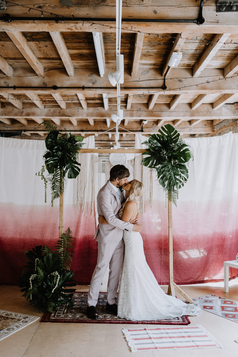 Backdrop Frame Arch Tropical Greenery Foliage Persian Rug Tie Die Fabric Botanical Industrial Wedding Caitlin and Jones Photography