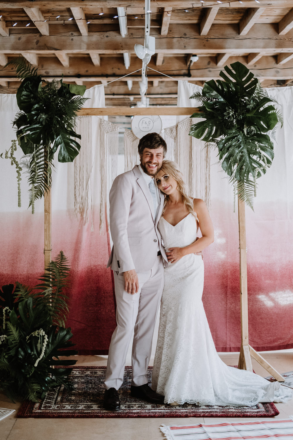 Backdrop Frame Arch Tropical Greenery Foliage Persian Rug Tie Die Fabric Botanical Industrial Wedding Caitlin and Jones Photography