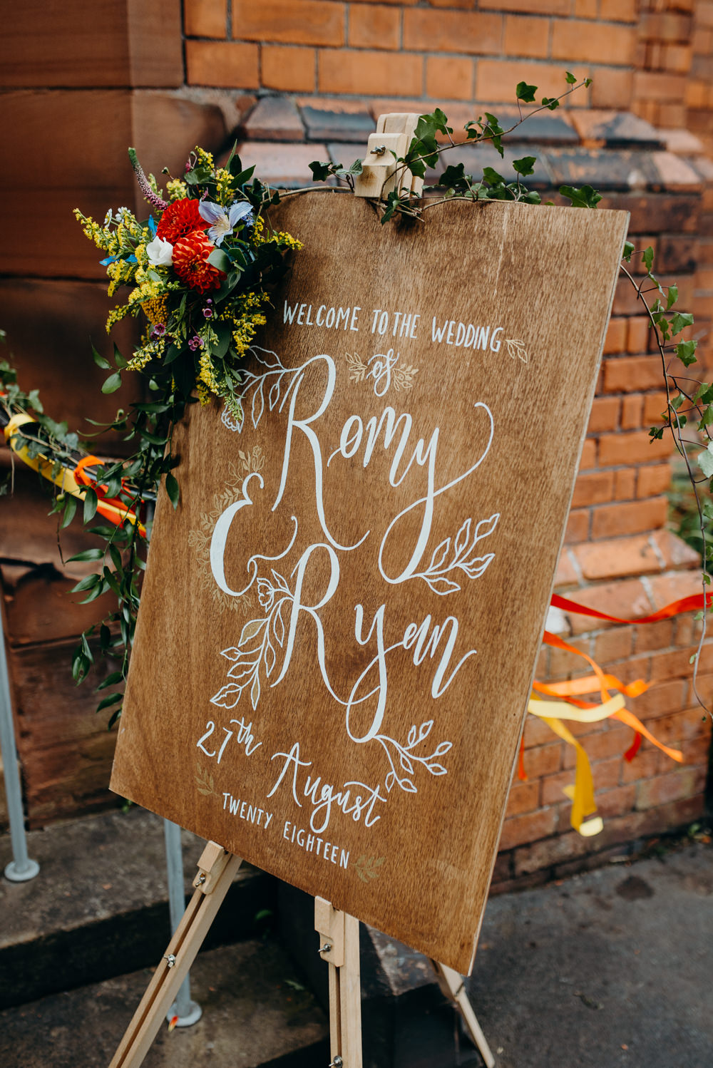 Wooden Welcome Sign Calligraphy Flowers Colourful Stretch Tent Wedding Peter Mackey Photography
