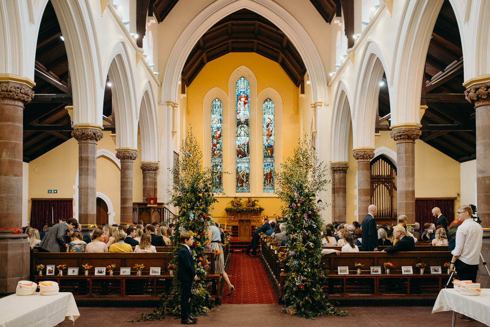 Church Flowers Aisle Pew End Installation Colourful Stretch Tent Wedding Peter Mackey Photography