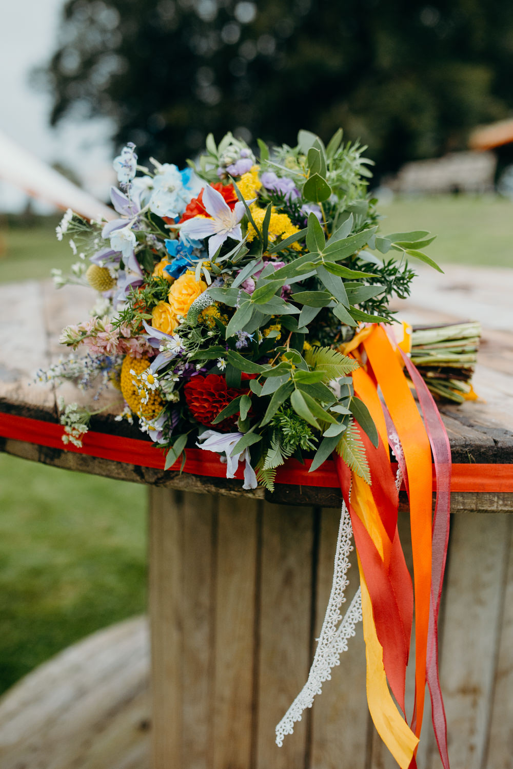 Bouquet Flowers Bride Bridal Rainbow Ribbons Wildflowers Wild Natural Colourful Stretch Tent Wedding Peter Mackey Photography