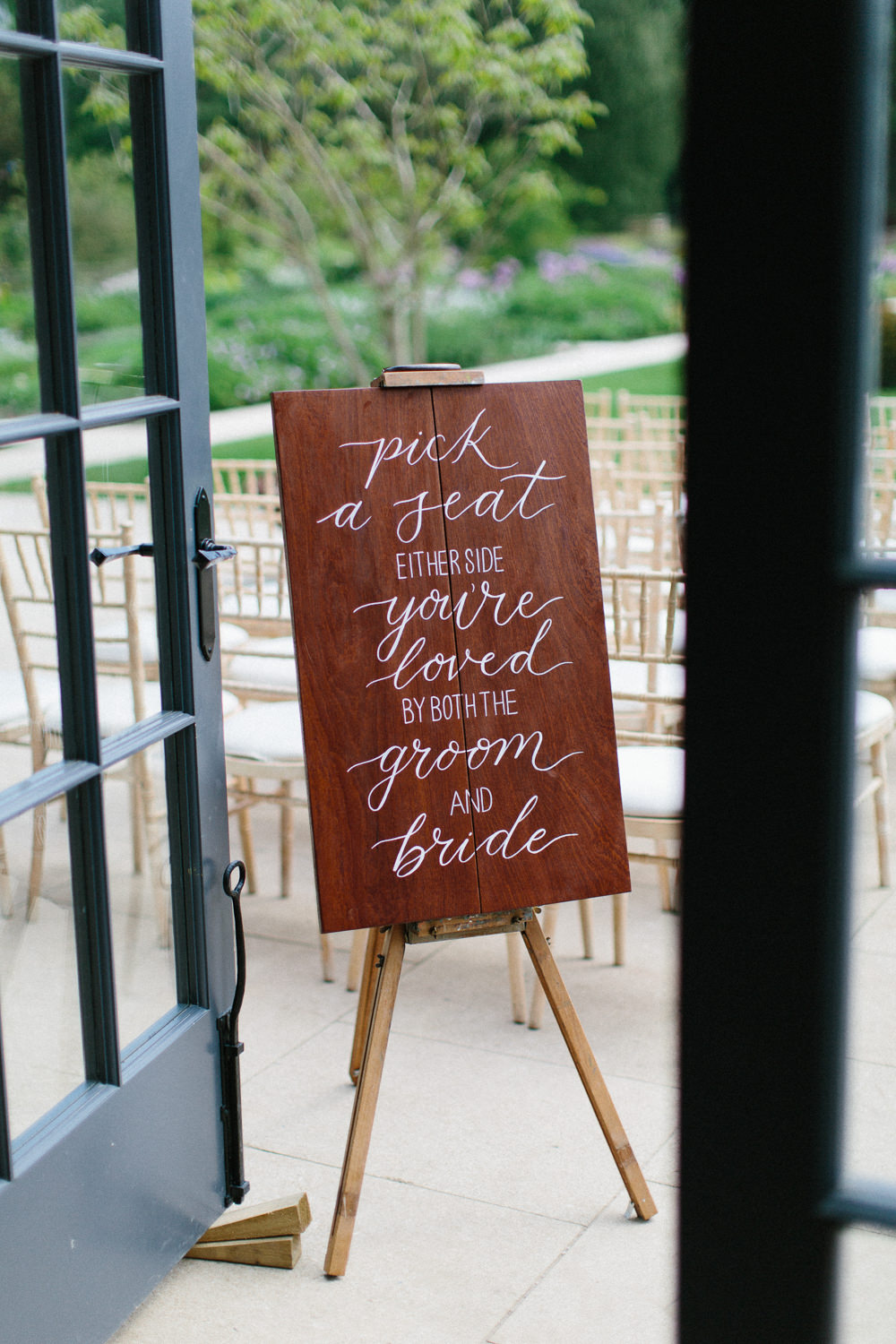Wooden Modern Calligraphy Sign Pick A Seat Not A Side Garden Ceremony Wedding Melissa Beattie Photography