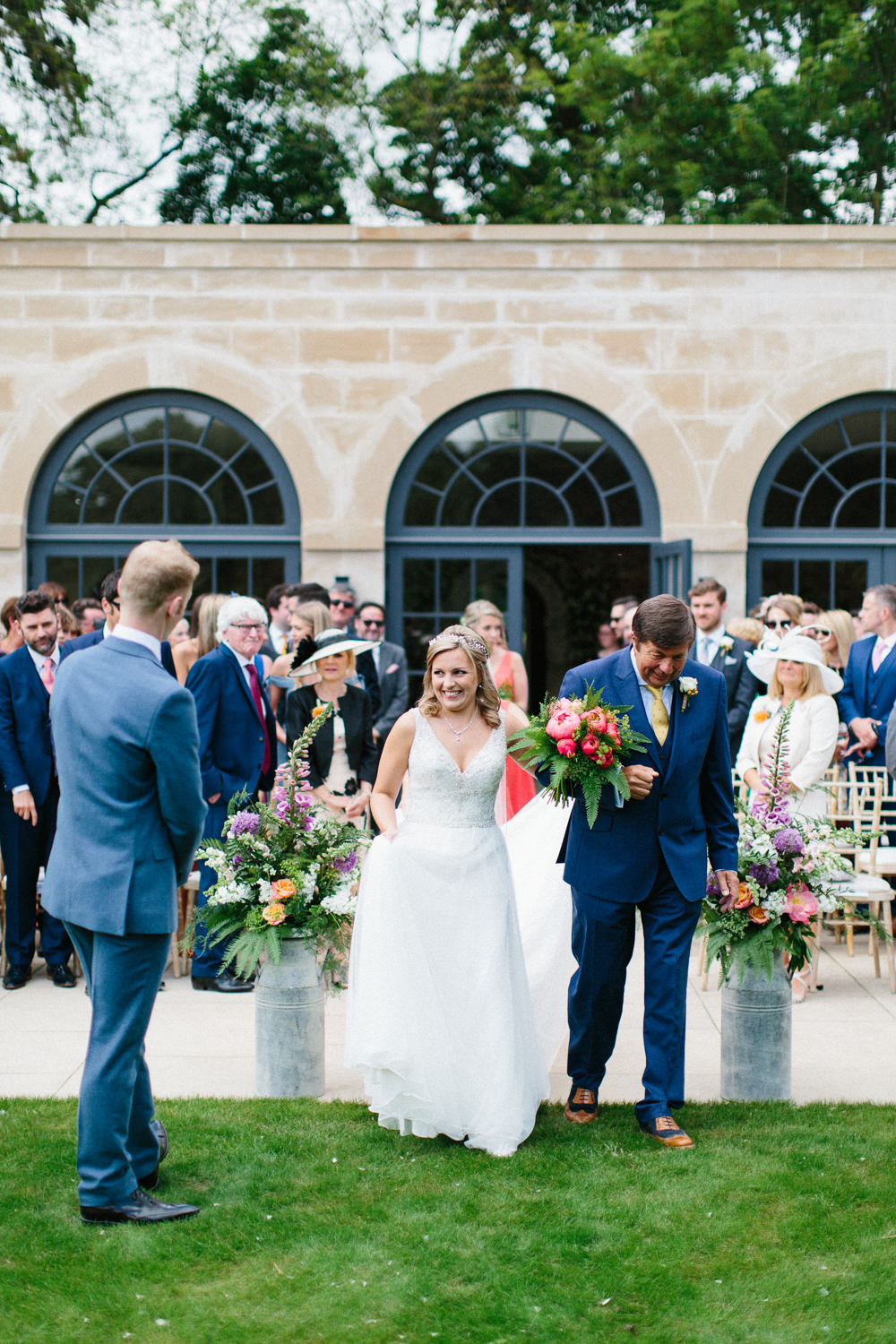 Bride Bridal Dress Sleeveless A Line Beaded Embellished V Neck Tiara Blue Suit Waistcoat Groom Veil Milk Churn Flowers Floral Garden Ceremony Wedding Melissa Beattie Photography