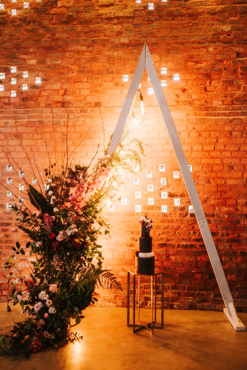 Triangle Backdrop Wooden Flower Arch Floral Installation Romantic Wedding Ideas Neon Lighting Kate McCarthy Photography