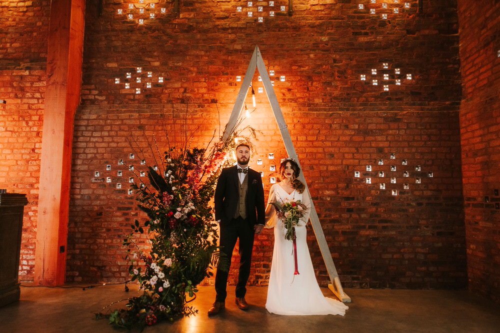 Triangle Backdrop Wooden Flower Arch Floral Installation Romantic Wedding Ideas Neon Lighting Kate McCarthy Photography