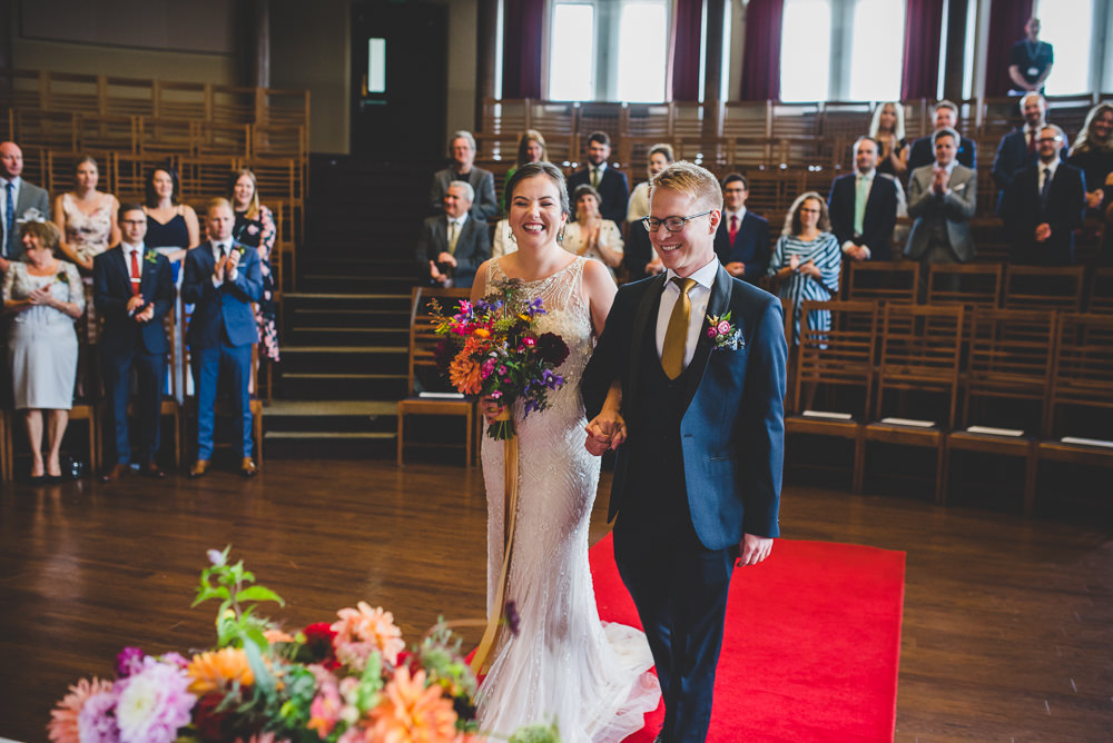Bride Bridal Beaded Embellished Dress Navy Blue Tuxedo Mustard Tie Groom Multicoloured Bouquet Victoria Gallery Museum Wedding Emma Hillier Photography