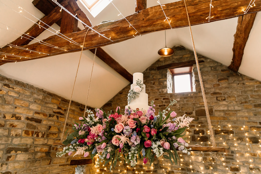 Suspended Hanging Swing Flowers Florals Pink Blue Pretty Cake Table Blossom Barn Wedding Ideas Hayley Baxter Photography
