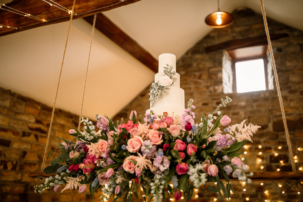 Suspended Hanging Swing Flowers Florals Pink Blue Pretty Cake Table Blossom Barn Wedding Ideas Hayley Baxter Photography