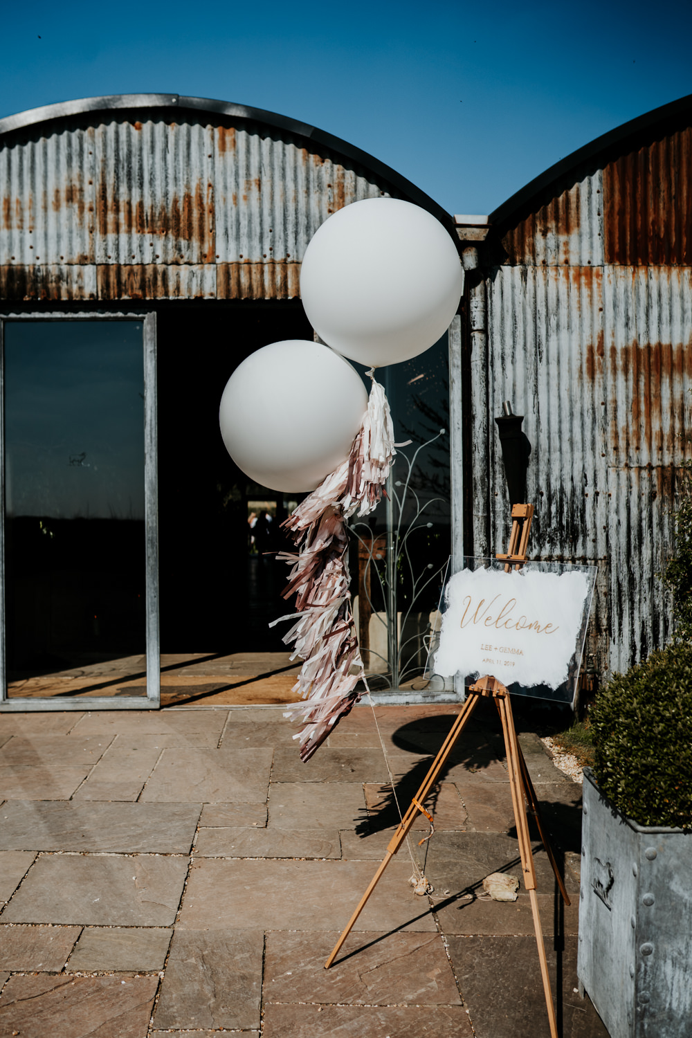 Welcome Sign Glass Easel Giant Oversized Balloons Tassel Tail Calligraphy Contemporary Barn Wedding Ryan Goold Photography
