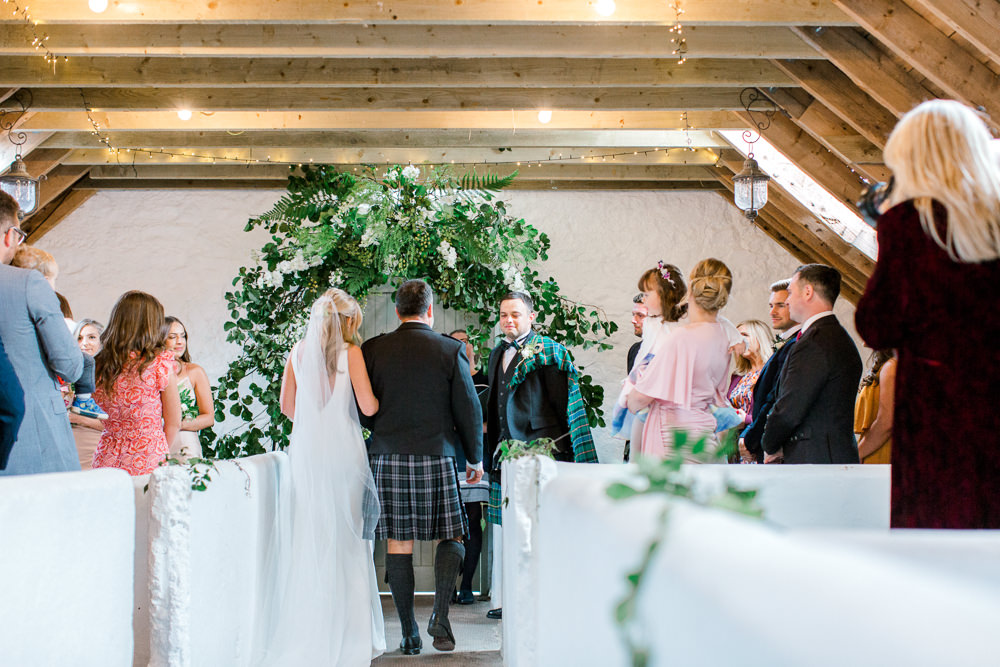 Bride Bridal Deep V Plunge Neckline Dress Sleeveless Slim Fit Ogilvie Tartan Kilt Groom Veil Foliage Arch Ceremony Tin Shed Knockraich Farm Wedding The Gibsons Photography