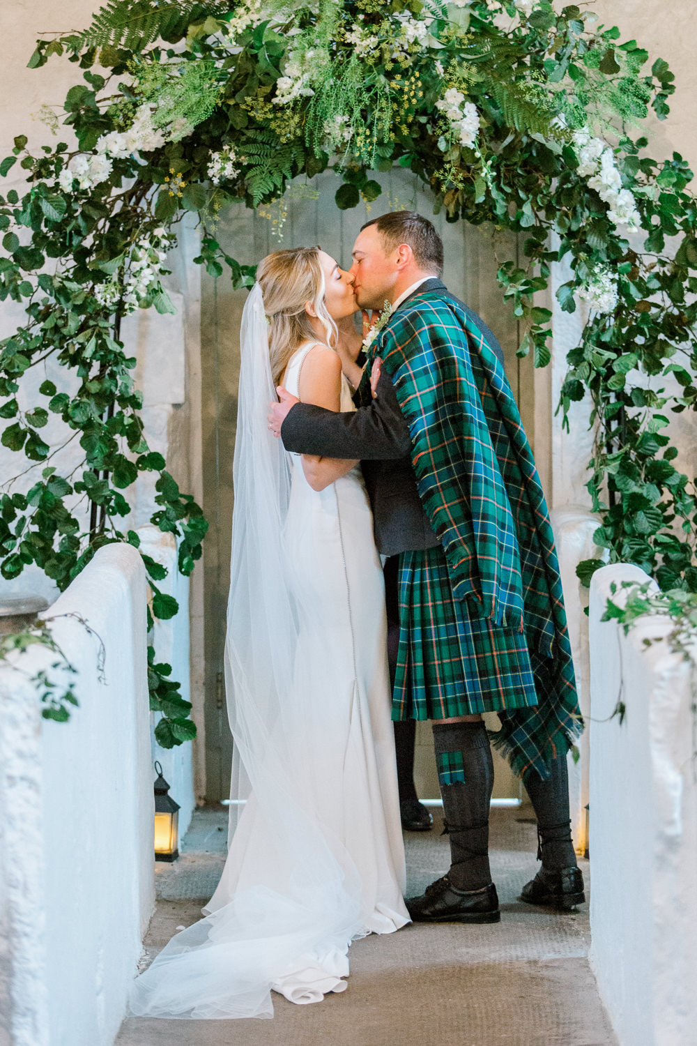 Bride Bridal Deep V Plunge Neckline Dress Sleeveless Slim Fit Ogilvie Tartan Kilt Groom Veil Foliage Arch Ceremony Tin Shed Knockraich Farm Wedding The Gibsons Photography