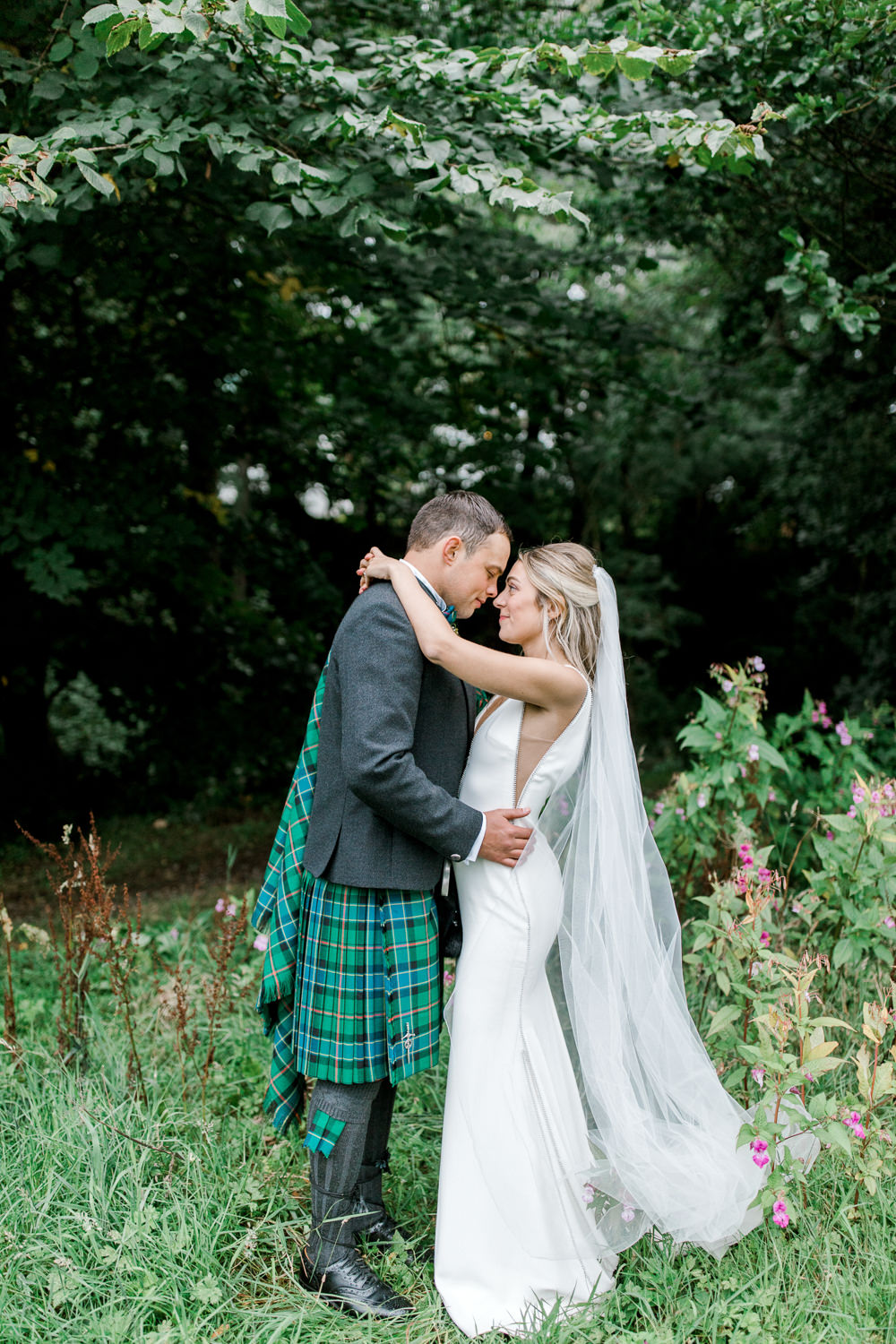 Bride Bridal Deep V Plunge Neckline Dress Sleeveless Slim Fit Ogilvie Tartan Kilt Groom Veil Tin Shed Knockraich Farm Wedding The Gibsons Photography