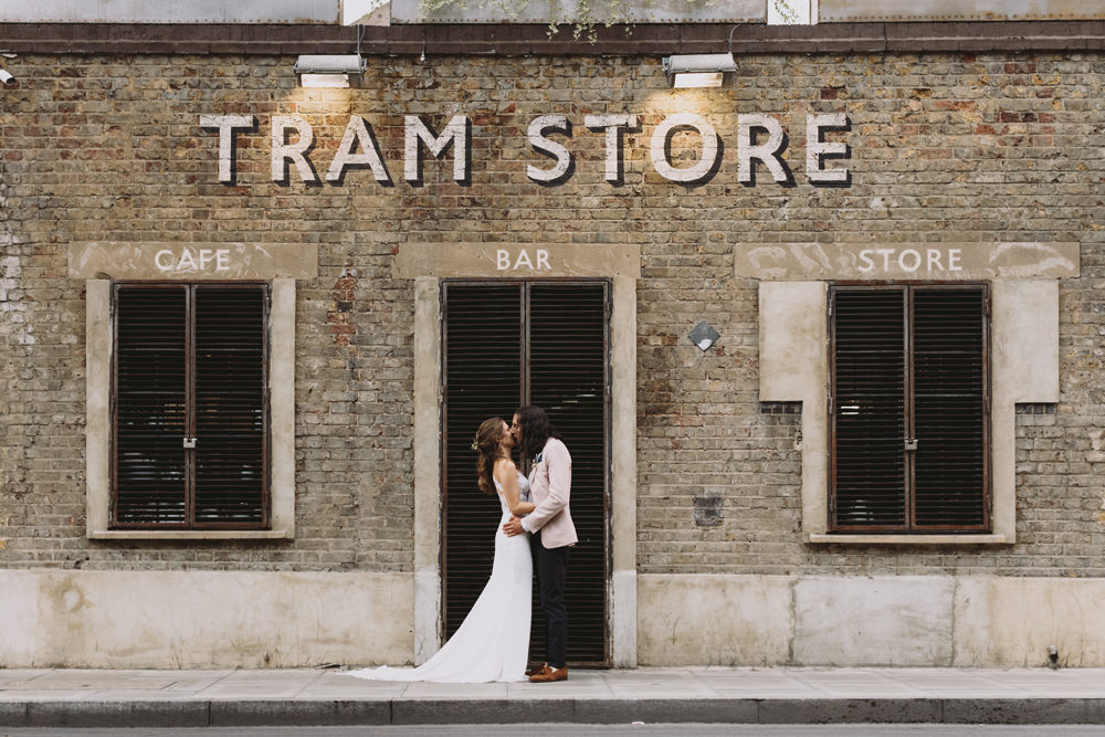 Bride Bridal Sleeveless V Neck Fit and Flare Train Pronovias Dress Gown Pink Jacket Reiss Groom Wild Bouquet Loose Handtied Rose Tram House Wedding Luke Hayden Photography