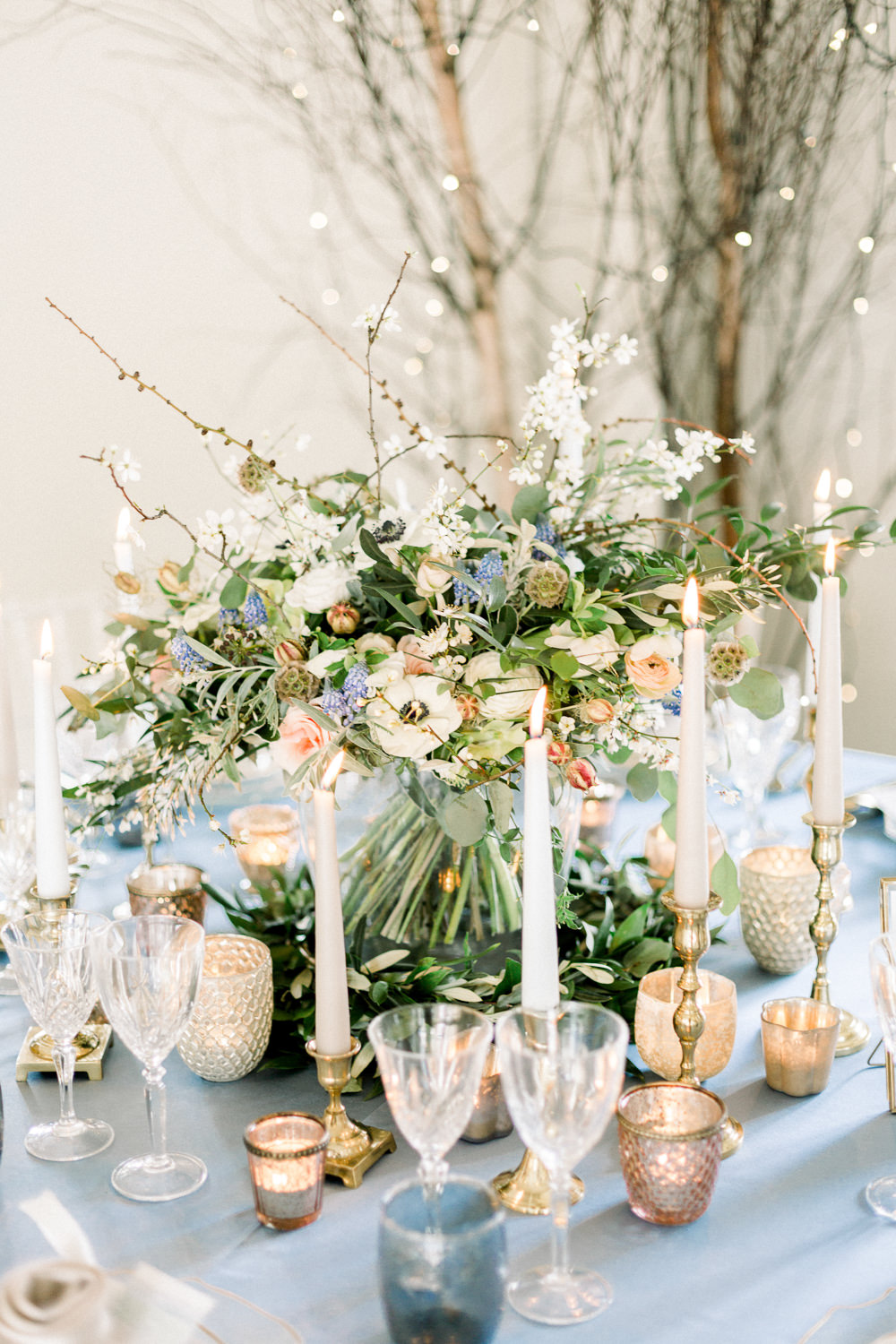 Table Flowers Centrepiece Candles Grape Hyacinth Anemone Greenery Folliage Nigella Seeds Scabious Blossom Winter Blue Barn Wedding Ideas Joanna Briggs Photography