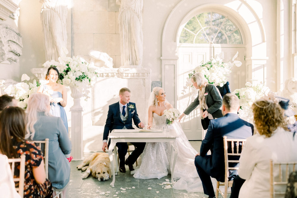 Bride Bridal Berta Princess Sparkly Dress Gown Veil Navy Tailcoat Groom Dog Ceremony Registrar table Aynhoe Park Wedding Sanshine Photography