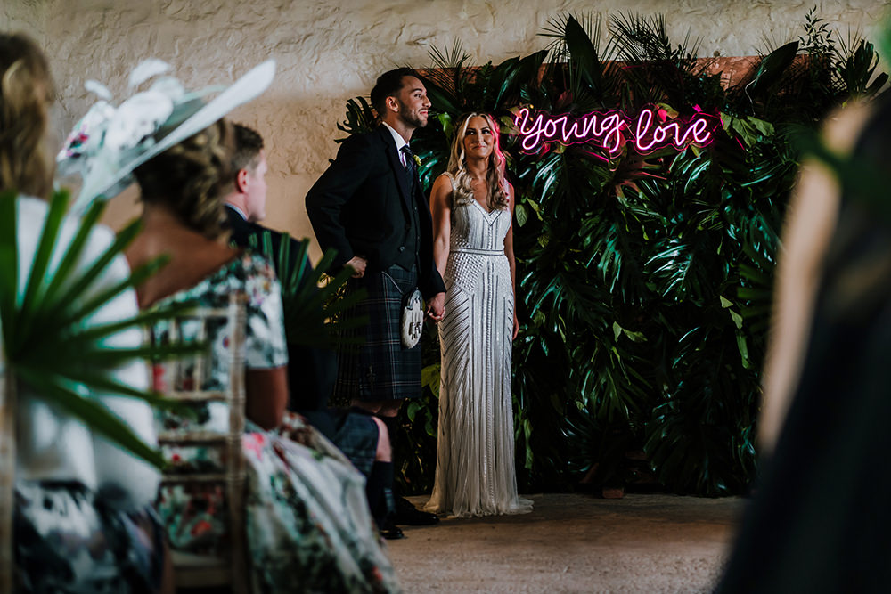 Bride Bridal Beaded Embellished V Neck Dress Gown Succulents Bouquet Kilt Groom Greenery Backdrop Ceremony Young Love Neon Tropical Luxe Wedding Burfly Photography