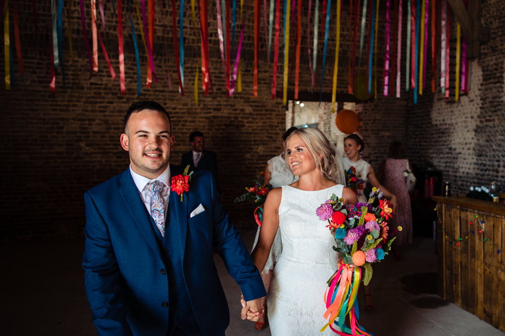 Bride Bridal Pronovias Dress Gown Boat Neck Fitted Multicoloured Pom Pom Bouquet Navy Suit Groom Waxham Great Barn Wedding Joshua Patrick Photography