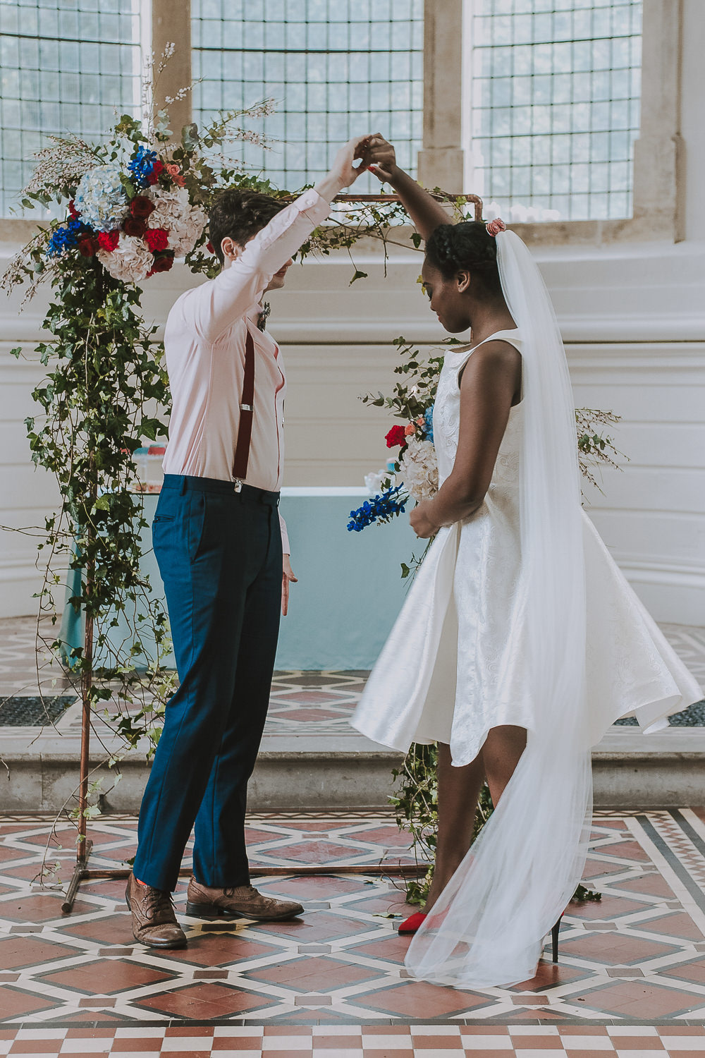 Flower Arch Backdrop Red Pink Blue Greenery Foliage Wes Anderson William Morris Wedding Ideas Jessica Hill Photography