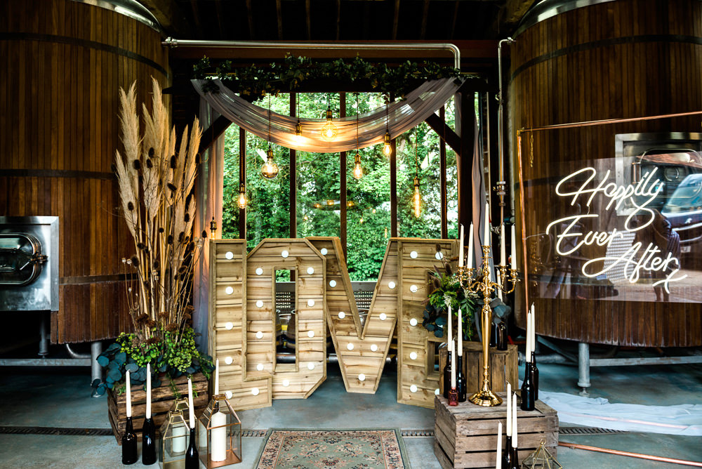 Decor Decoration Backdrop Ceremony Fetoon Lights Edison Lightbulbs Flower Arch Pampas Grass Crates Candles LOVE Letters Neon Sign Signage Signs Indie Wedding Ideas Kat Antos-Lewis Photography