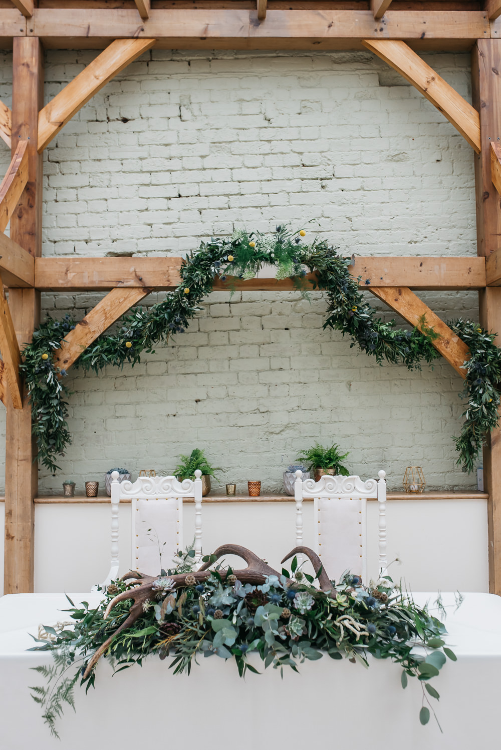 Top Table Greenery Foliage Wreath Antlers Thrones Quirky Rustic Charm Wedding Justin Bailey Photography