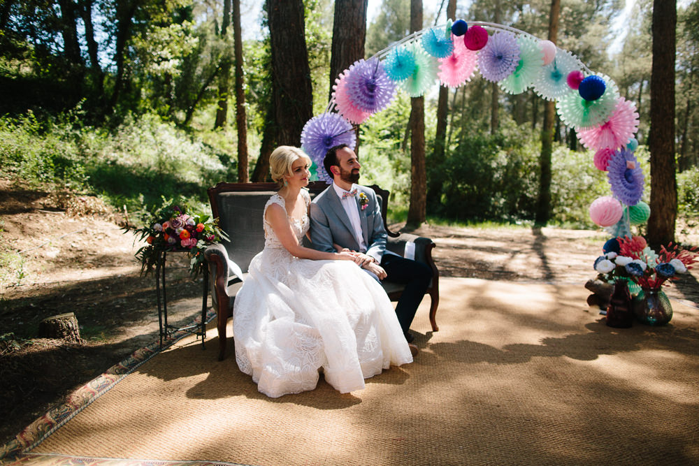 Bride Bridal Lace Strappy Sleeveless Embellished Dress Gown Mismatched Bow Tie Groom Paper Lantern Pin Wheel Arch Forest Spain Destination Wedding Dan Hough Photography