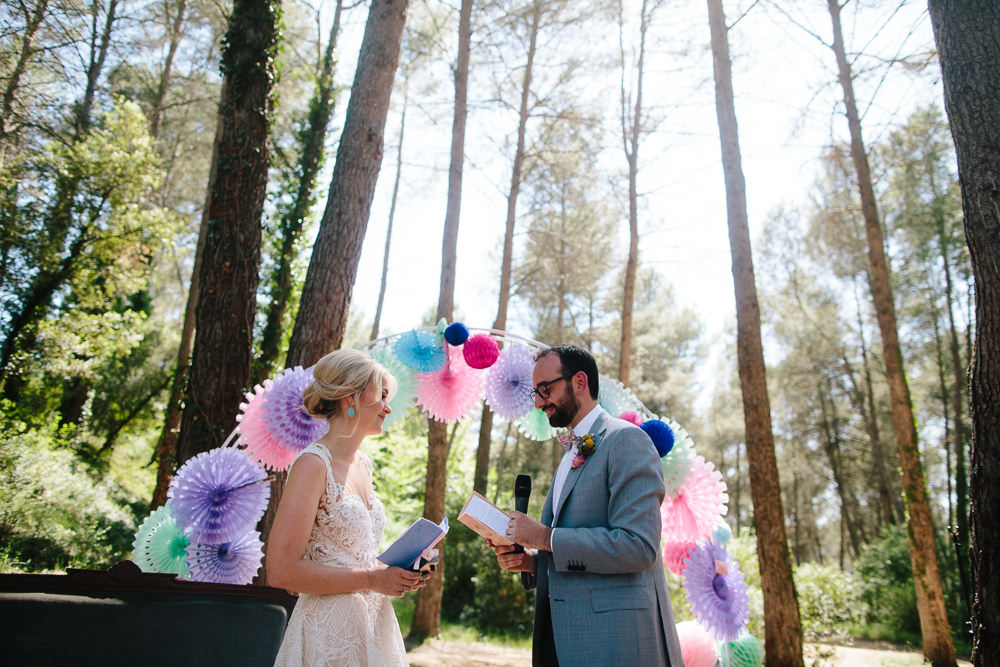 Bride Bridal Lace Strappy Sleeveless Embellished Dress Gown Mismatched Bow Tie Groom Pin Wheel Paper Lantern Arch Purple Pink Colourful Forest Spain Destination Wedding Dan Hough Photography