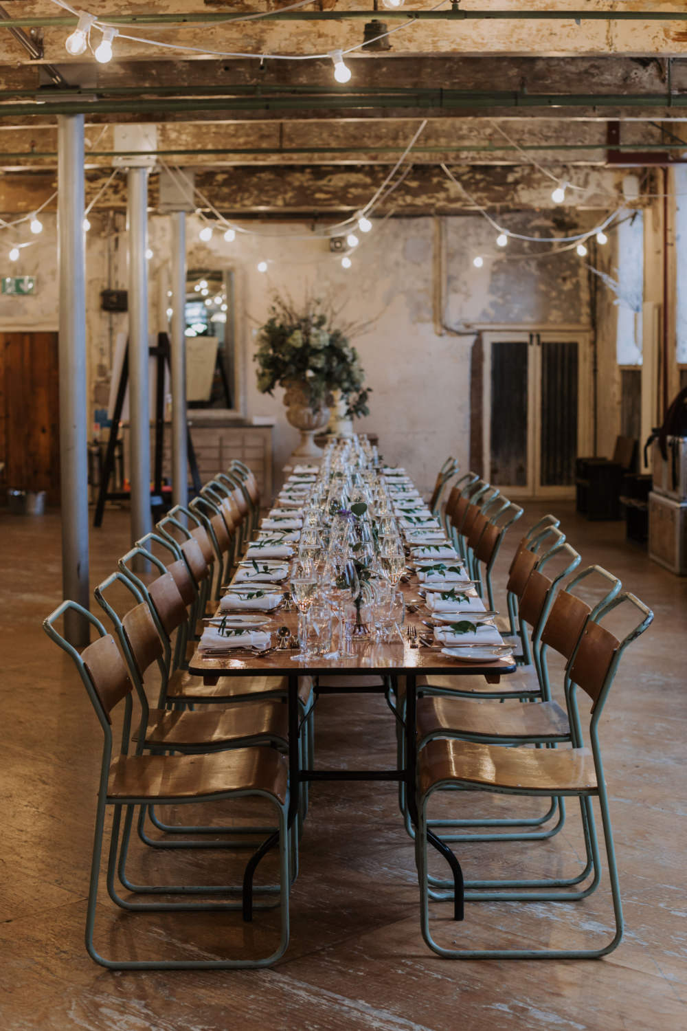 Industrial Decor Reception Long Tables Wooden Festoon Lights Greenery Foliage Chairs Holmes Mill Wedding Siobhan Amy Photography