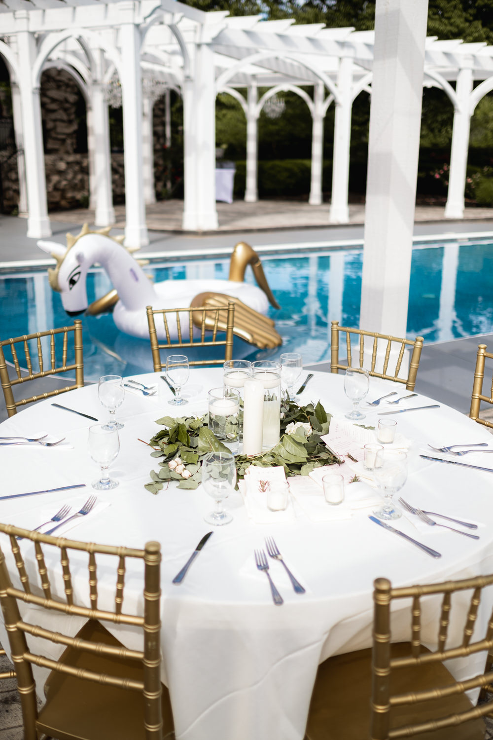 Outdoor Pool Reception Venue Round Tables Gold Chairs Greenery Centrepiece Foliage Missouri Wedding Nick Mehn Photography
