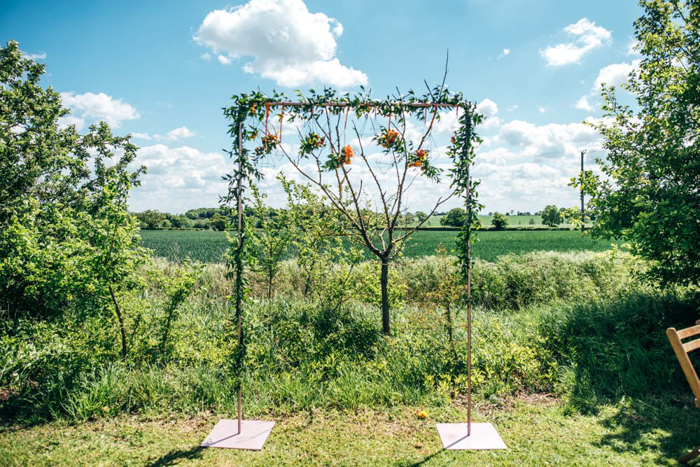Ceremony Aisle Frame Arch Backdrop Greenery Foliage Flowers Outdoor DIY Wedding Three Flowers Photography