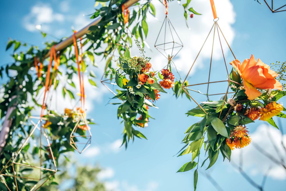 Ceremony Aisle Frame Arch Backdrop Greenery Foliage Flowers Terrarium Orange Roses Outdoor DIY Wedding Three Flowers Photography
