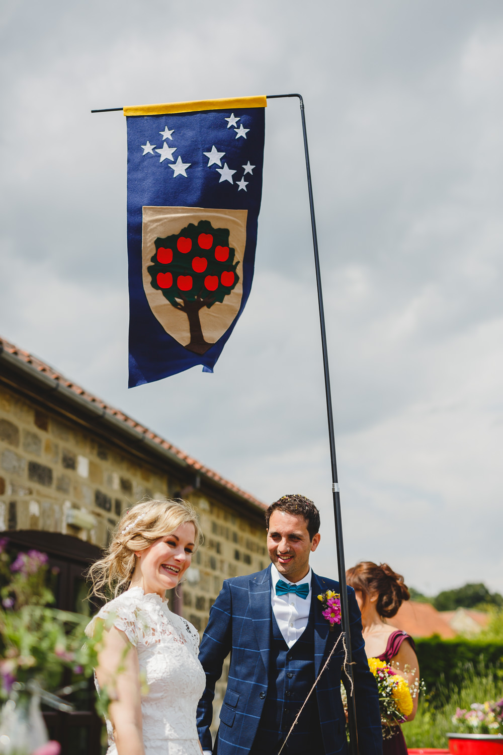 Bride Bridal High Neck Cap Sleeve Lace Fitted Dress Gown Bow Tie Waistcoat Groom Family Crest Flag East Keswick Village Hall Wedding James & Lianne Wedding Photography