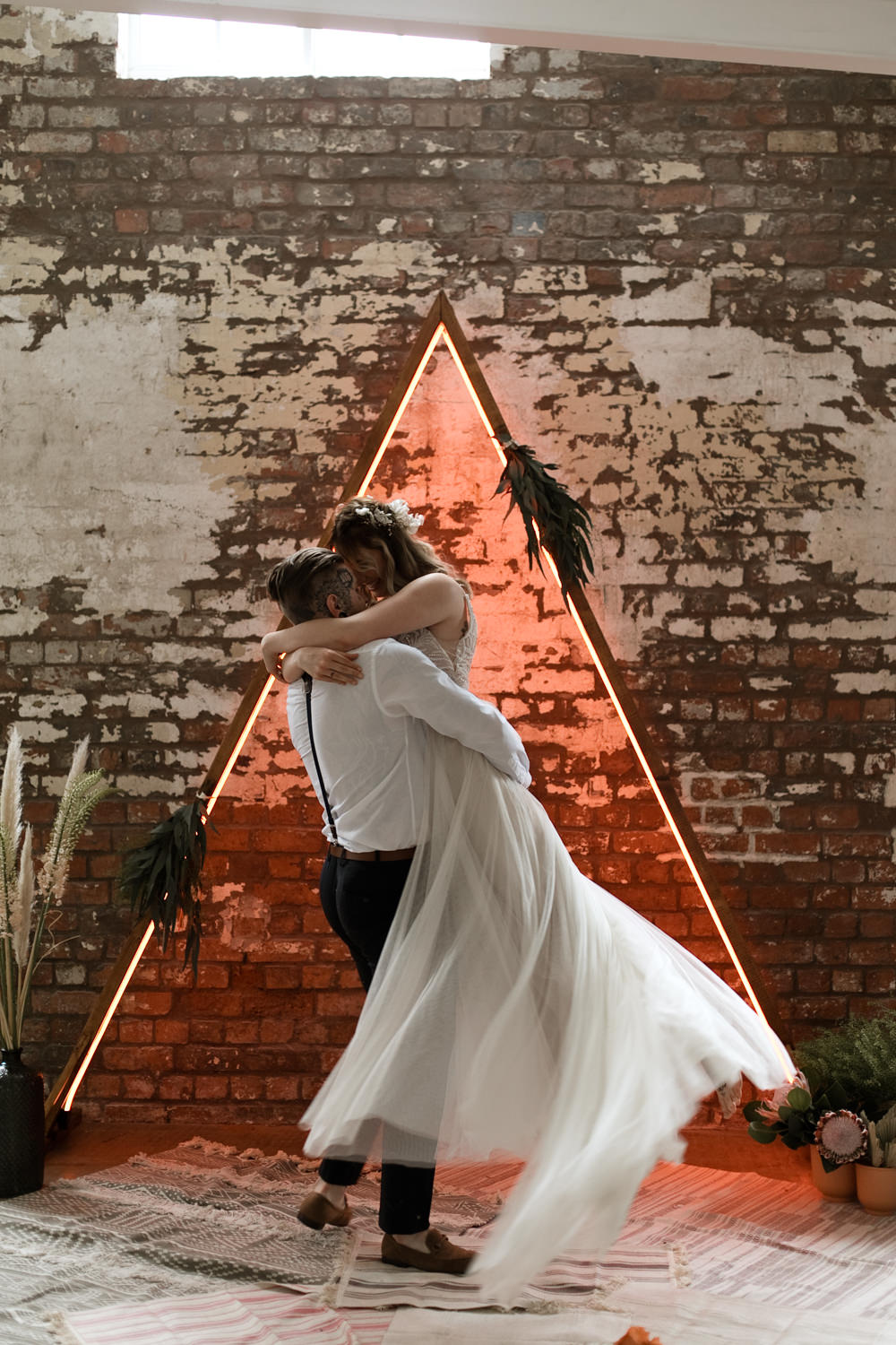Triangle Backdrop Wooden Frame Neon Lighting Ceremony Greenery Foliage Moroccan Wedding Ideas Emma Louise Photography