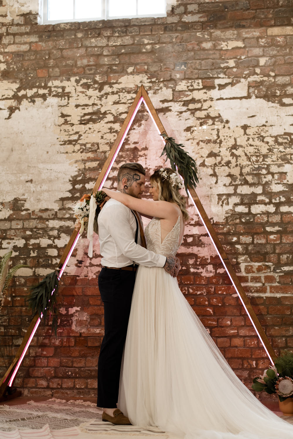 Triangle Backdrop Wooden Frame Neon Lighting Ceremony Greenery Foliage Moroccan Wedding Ideas Emma Louise Photography