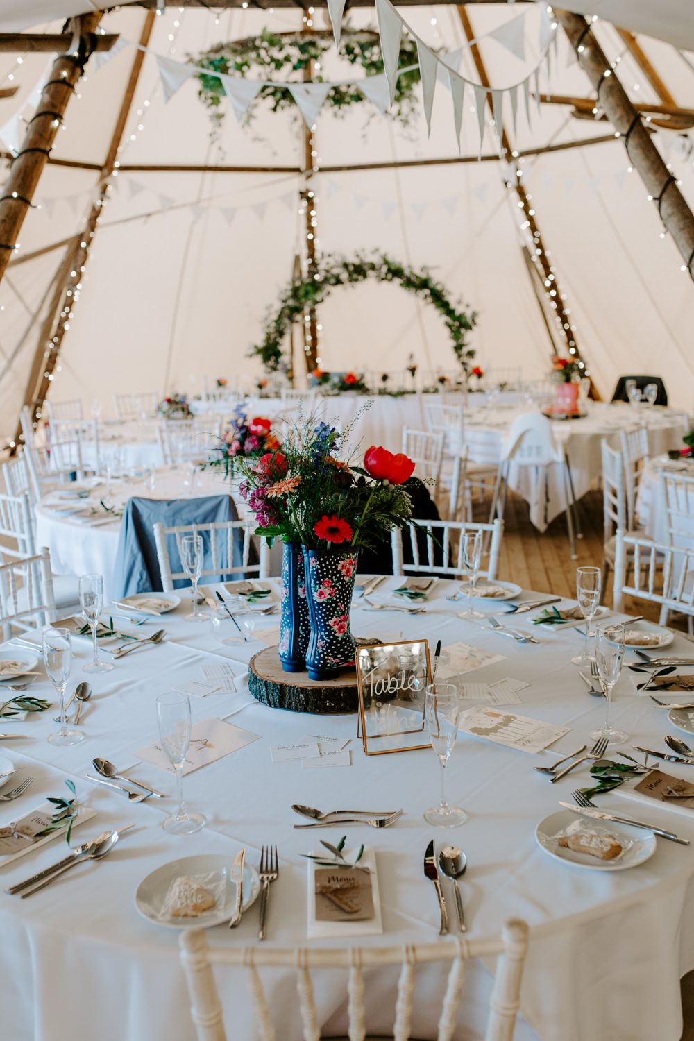 Table Centre Wellies Wood Slice Log Flowers Floral Colourful Tipi Bunting Tipis Riley Green Wedding Jessica Isherwood Photography