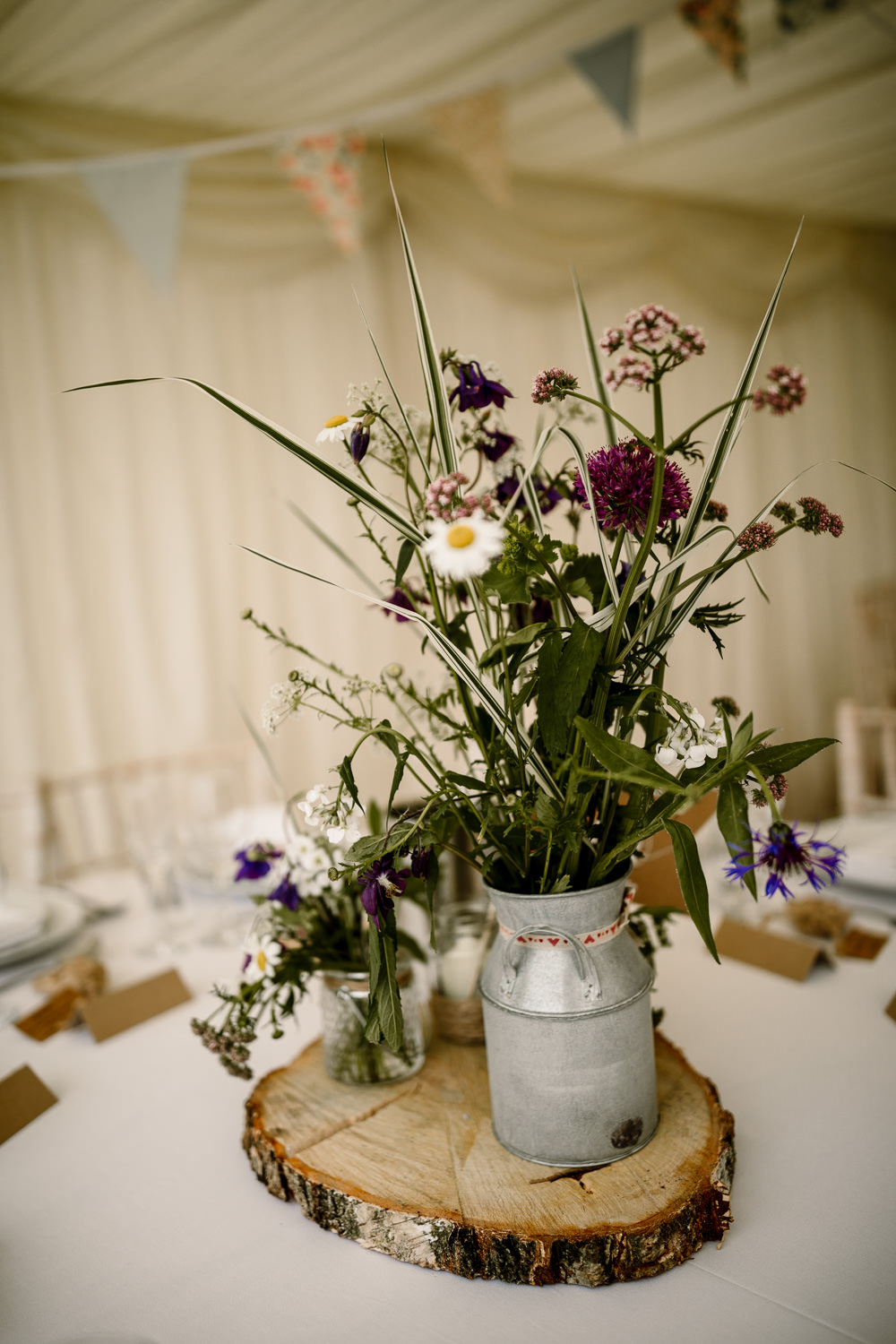 Centrepiece Table Decor Decorations Log Slice Jug Flowers Purple Pennant Flag Table Name Candle Yorkshire Barn Wedding Hayley Baxter Photography