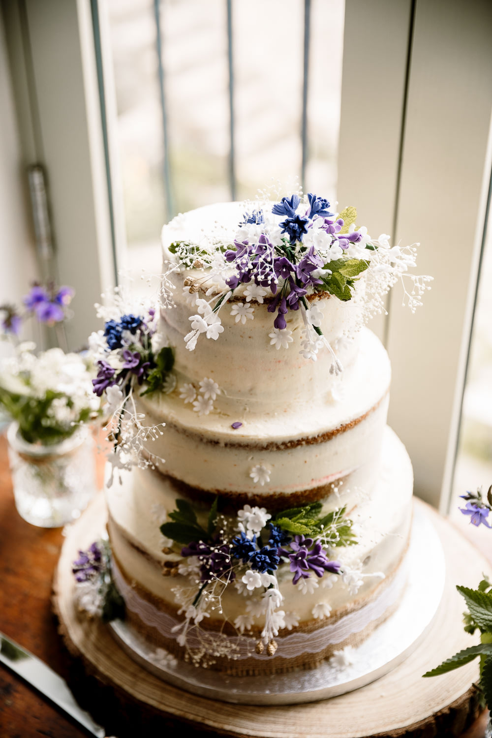 Semi Naked Cake Buttercream Flowers Purple White Yorkshire Barn Wedding Hayley Baxter Photography