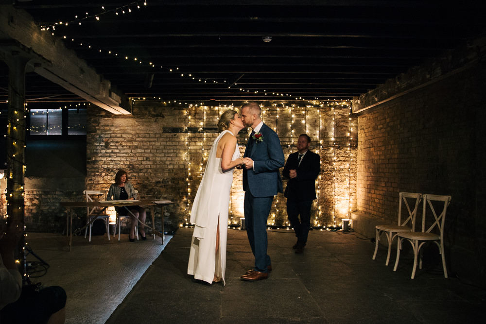 Electrician’s Shop Trinity Buoy Wharf Ceremony Fairy Lights Bridal Jumpsuit Wedding Emily Jarrett Photography
